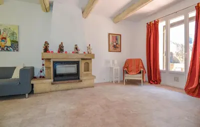 a living room with a couch and a fireplace at Maison de Village avec jardin dans Centre historique in Eyguières