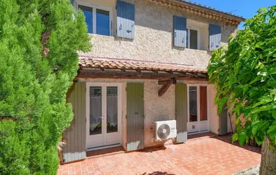 an exterior view of a house with a yard at Maison de Village avec jardin dans Centre historique in Eyguières