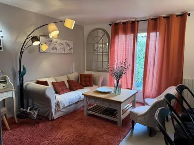 a living room with a couch and a table at Le clos de l’artichaut in Eyguières