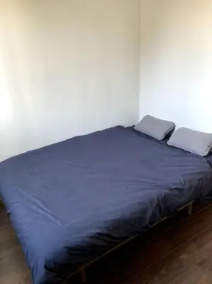 a bed with two pillows on it in a room at Appartement entier au RDC in Salon-de-Provence