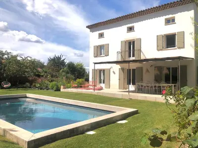 a villa with a swimming pool in front of a house at Hope, villa à Aix en Provence in Aix-en-Provence