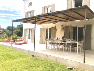 a swimming pool in a yard with two chairs at Hope, villa à Aix en Provence in Aix-en-Provence