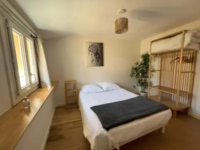 a bedroom with a bed and a window at Hypercenter lovely duplex with Terrace CLIM WIFI in Aix-en-Provence