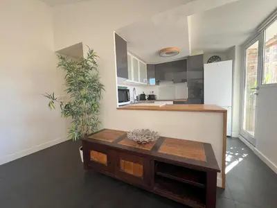 a living room with a table and a kitchen at Hypercenter lovely duplex with Terrace CLIM WIFI in Aix-en-Provence