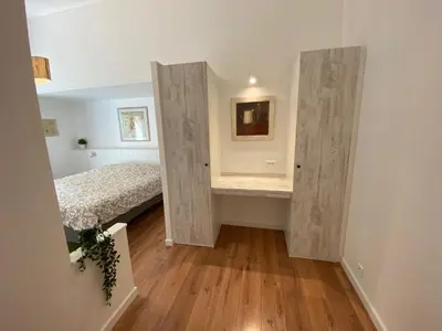 a bedroom with doors leading to a bed at La Bastide au Ventoux in Bédoin