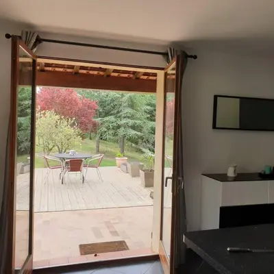 a living room with a couch and a table at Appartement dans campagne aixoise in Ventabren