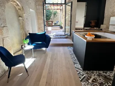 a kitchen with blue chairs and a counter and a table at Le Spacieux - Un Voyage en Provence- Offre de lancement in Aix-en-Provence