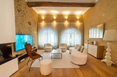 a large living room with white furniture and a television at Le Spacieux - Un Voyage en Provence- Offre de lancement in Aix-en-Provence