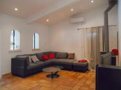a living room with a couch and a table at Maison de campagne avec Piscine in Pernes-les-Fontaines