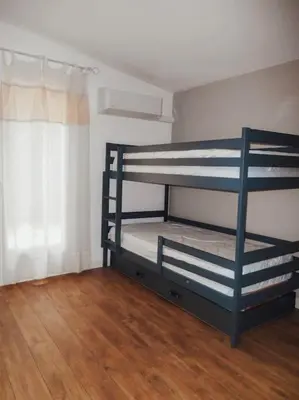a room with a bunk bed with a wooden floor at Maison de campagne avec Piscine in Pernes-les-Fontaines