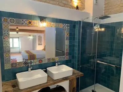 a bathroom with two sinks and a shower and a mirror at Grande maison de charme au coeur de Goult in Goult