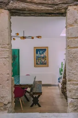 a dining room with a table and a picture on the wall at Grande maison de charme au coeur de Goult in Goult
