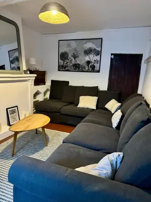 a living room with a couch and a table at La maison Haut-perché townhouse with view and jacuzzi in Saumane-de-Vaucluse