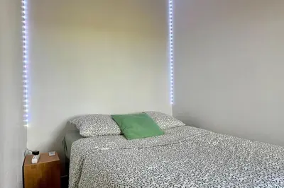 a bedroom with a bed with a green pillow at La maison Haut-perché townhouse with view and jacuzzi in Saumane-de-Vaucluse