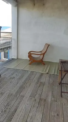 a wooden chair sitting on a floor in a room at Luberon sud in La Bastidonne