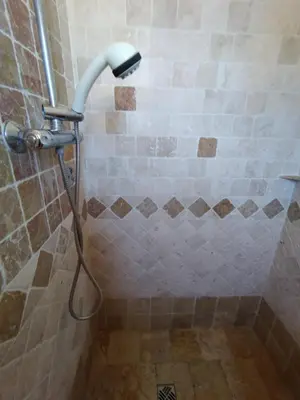 a shower with a shower head in a bathroom at Luberon sud in La Bastidonne