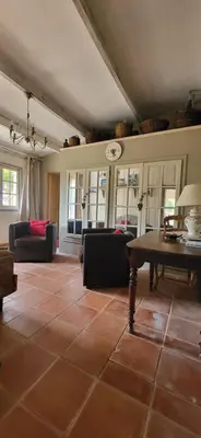 a living room with a couch and a table at Une maison de famille dans le Luberon in Bonnieux