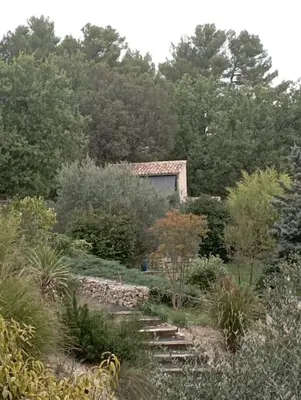a house in the middle of a garden at maisonnette provençale piscine le petit colibri in Les Cordiers