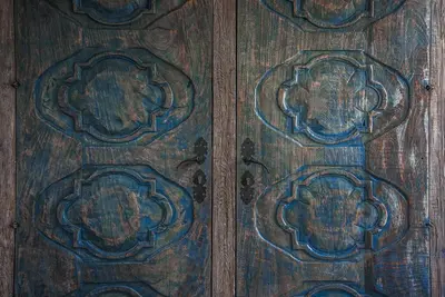 a wooden door with intricate designs on it at Superbe Mas provençal, entre Gordes et Roussillon in Murs