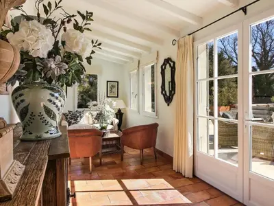a room with a vase of flowers on a table at Les Blayons - Exclusive Pool Villa Stunning View in Bonnieux