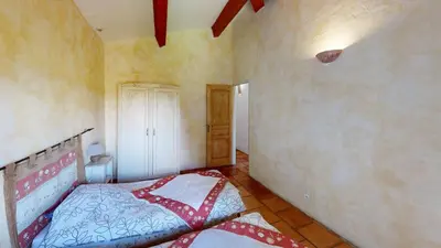 a bedroom with a bed in the corner of a room at Lei Meissoun in Mallemort