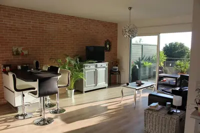 a living room with a black table and chairs at Bel appartement 1 chambre - résidence de standing in Aix-en-Provence