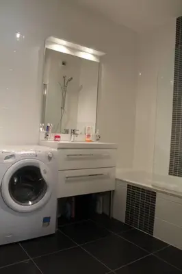 a washing machine in a bathroom with a mirror at Bel appartement 1 chambre - résidence de standing in Aix-en-Provence
