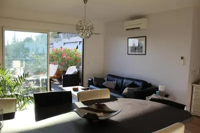 a living room with a bed and a couch and a living room at Bel appartement 1 chambre - résidence de standing in Aix-en-Provence