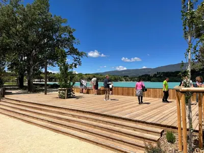 a group of people walking on a wooden boardwalk at Nature in Cabrières-dʼAigues