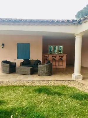 a patio with two couches and a table at Villa l'Hestia avec piscine à l'Isle-sur-Sorgue in LʼIsle-sur-la-Sorgue