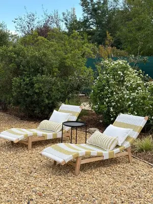 a group of three lounge chairs and a table at Le petit Auzon in Mazan