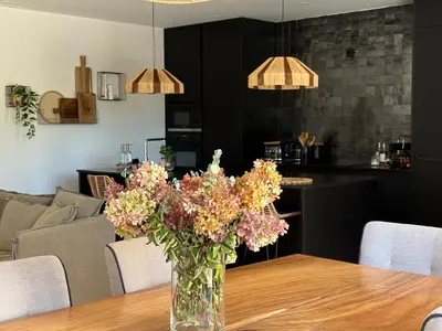 a vase of flowers sitting on a wooden table at Le petit Auzon in Mazan