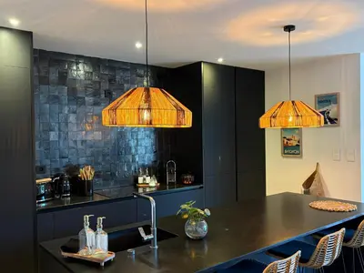 a kitchen with two pendant lights and a counter at Le petit Auzon in Mazan