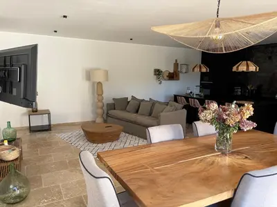 a living room with a table and a couch at Le petit Auzon in Mazan