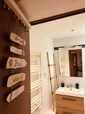 a bathroom with a sink and towels on a wall at Studio Oasis de paix centre Aix en Provence in Aix-en-Provence