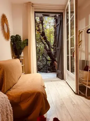 a bedroom with a bed and a sliding glass door at Studio Oasis de paix centre Aix en Provence in Aix-en-Provence