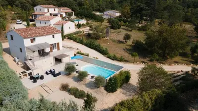 an aerial view of a house with a swimming pool at La Petite Colline in Apt