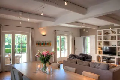 a large kitchen with a table in a room at Les Douze Oliviers in Ménerbes