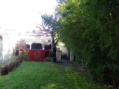 a garden with a fence and a tree in a yard at Le Souliadou in Saint-Didier