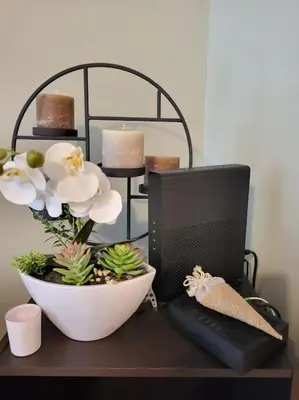 a desk with a computer monitor and a bowl of flowers at Le temps d'un instant in Salon-de-Provence