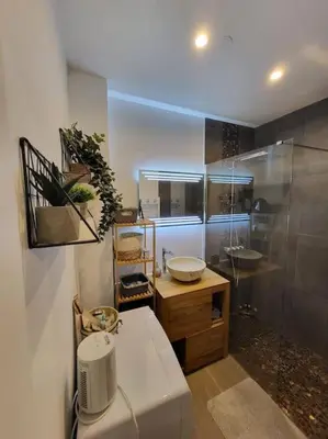 a bathroom with a sink and a shower and a counter at Le temps d'un instant in Salon-de-Provence