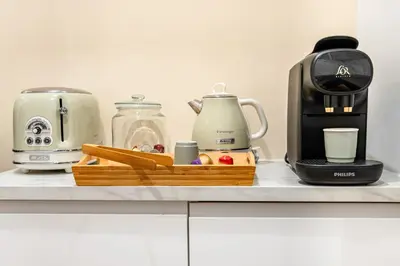 a kitchen counter with a coffeemaker and a coffee maker at Suite cosy dans le centre historique in Aix-en-Provence