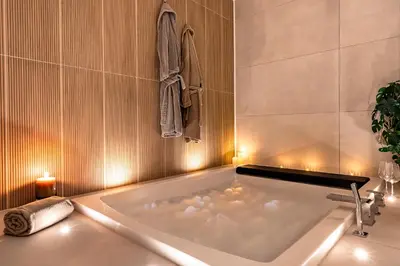 a bathroom with a bath tub with candles in it at Suite cosy dans le centre historique in Aix-en-Provence