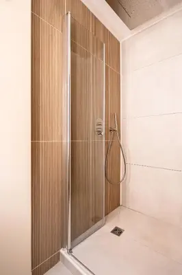 a shower with a glass door in a bathroom at Suite cosy dans le centre historique in Aix-en-Provence