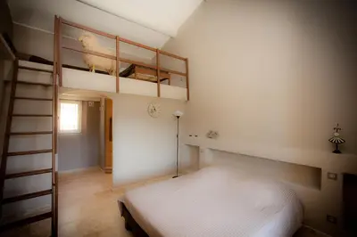 a bedroom with a bunk bed and a ladder at La Collina De Rve in Apt