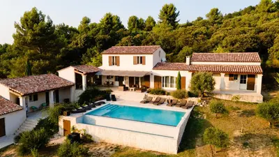 an aerial view of a house with a swimming pool at La Collina De Rve in Apt