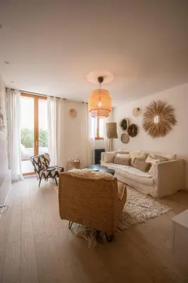 a living room with a couch and a table at Le Baudelaire - magnifique appartement au cœur du centre historique in Aix-en-Provence