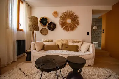 a living room with a couch and a table at Le Baudelaire - magnifique appartement au cœur du centre historique in Aix-en-Provence