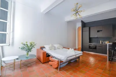 a living room with a couch and a table at Élégant Appartement Standing à 3min du Cours Mirabeau in Aix-en-Provence