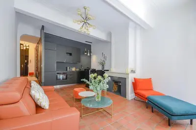 a living room with a couch and a table at Élégant Appartement Standing à 3min du Cours Mirabeau in Aix-en-Provence